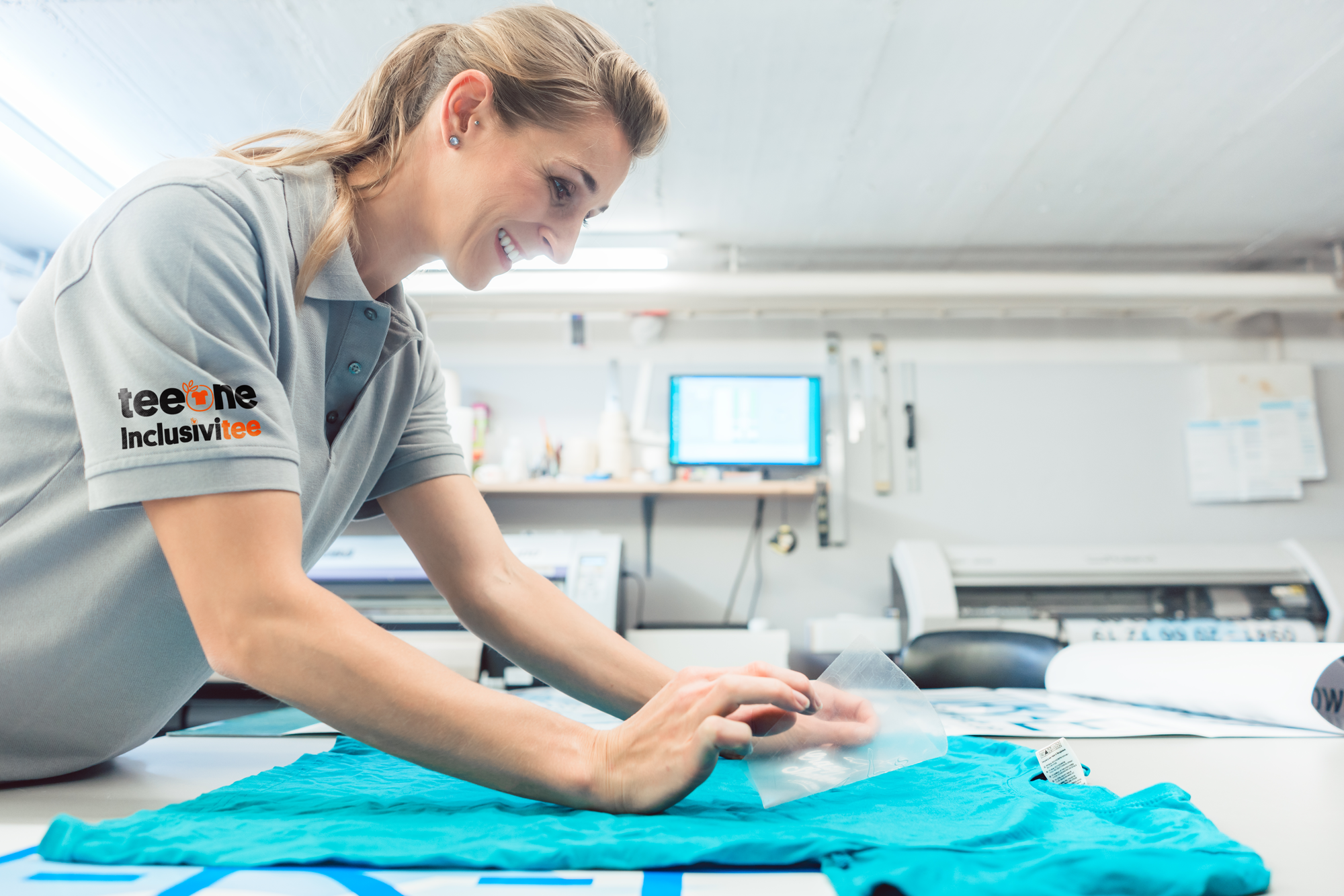 Efficiency in Action: teeone Employee Producing Garment with Direct to Film Print for Same Day Dispatch